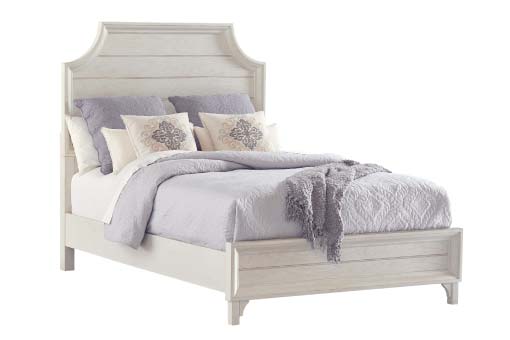 White farmhouse-chic wood bed with lilac bed accessories