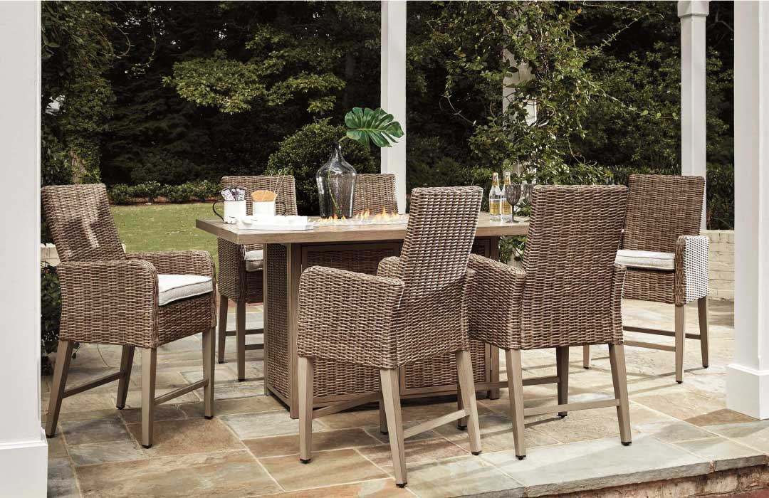 Outdoor pub height dining collection with rattan chairs and fire table