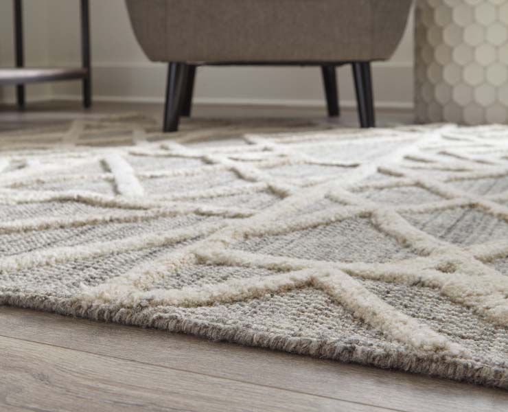 White rug with legs of chair in background