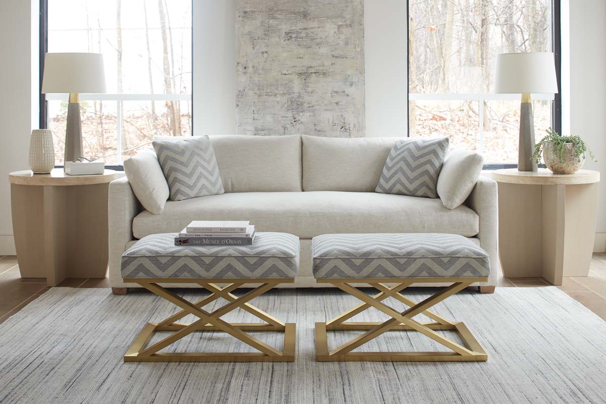 A white upholstery couch and two matching ottomans from Rowe & Robin Bruce